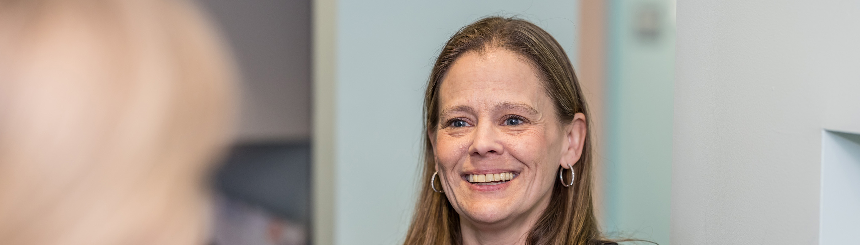 Receptionist smiling at a patient.